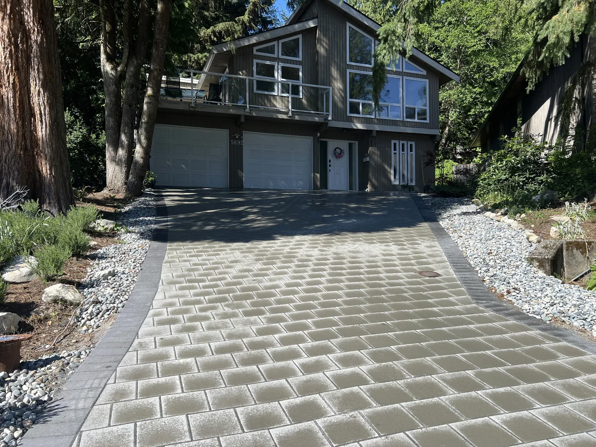 Finished paver driveway sweeping up to the garage.