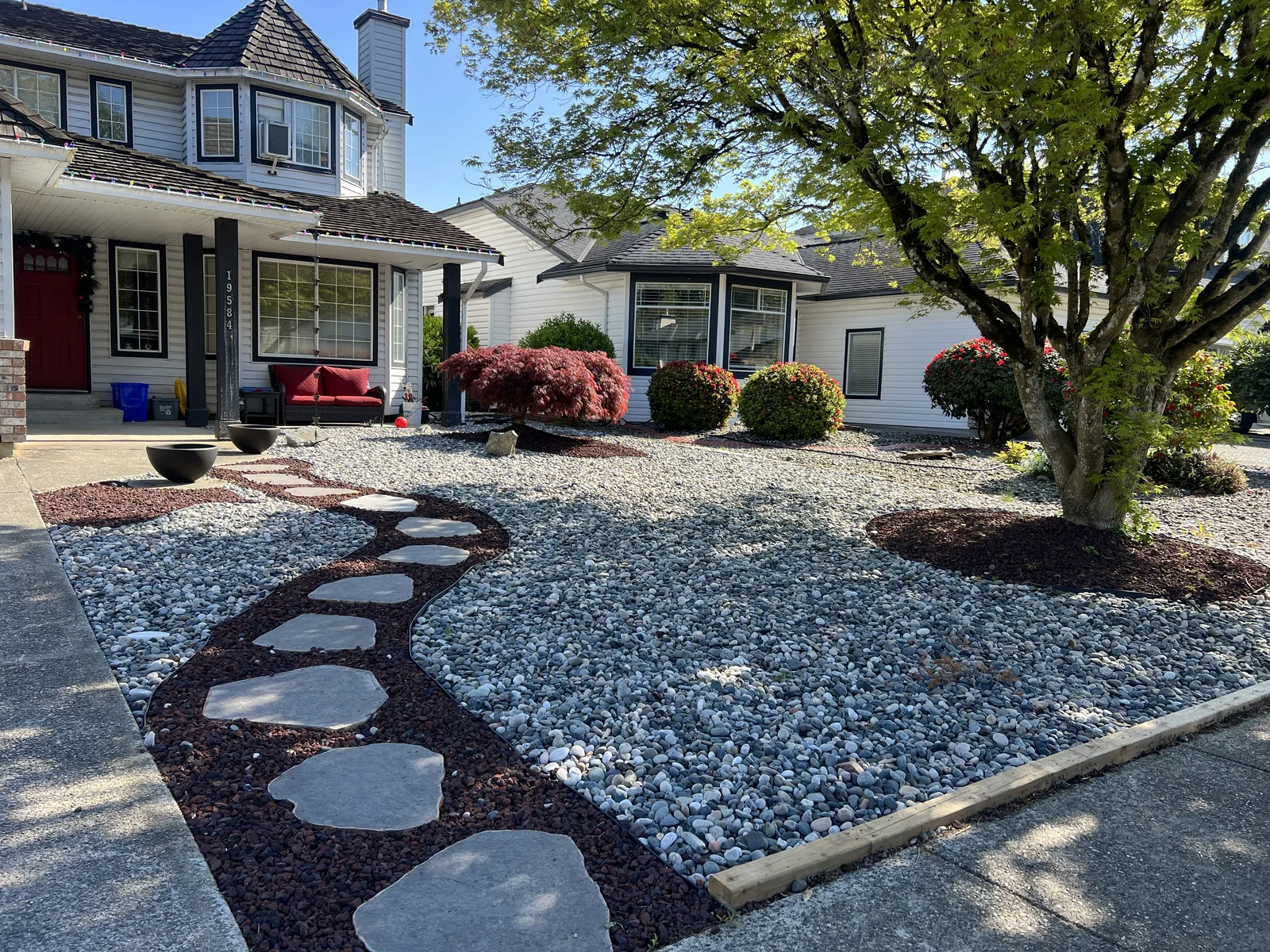 Modern Garden Retreat — dry garden with layered planting and a stone walkway in Maple Ridge, BC.