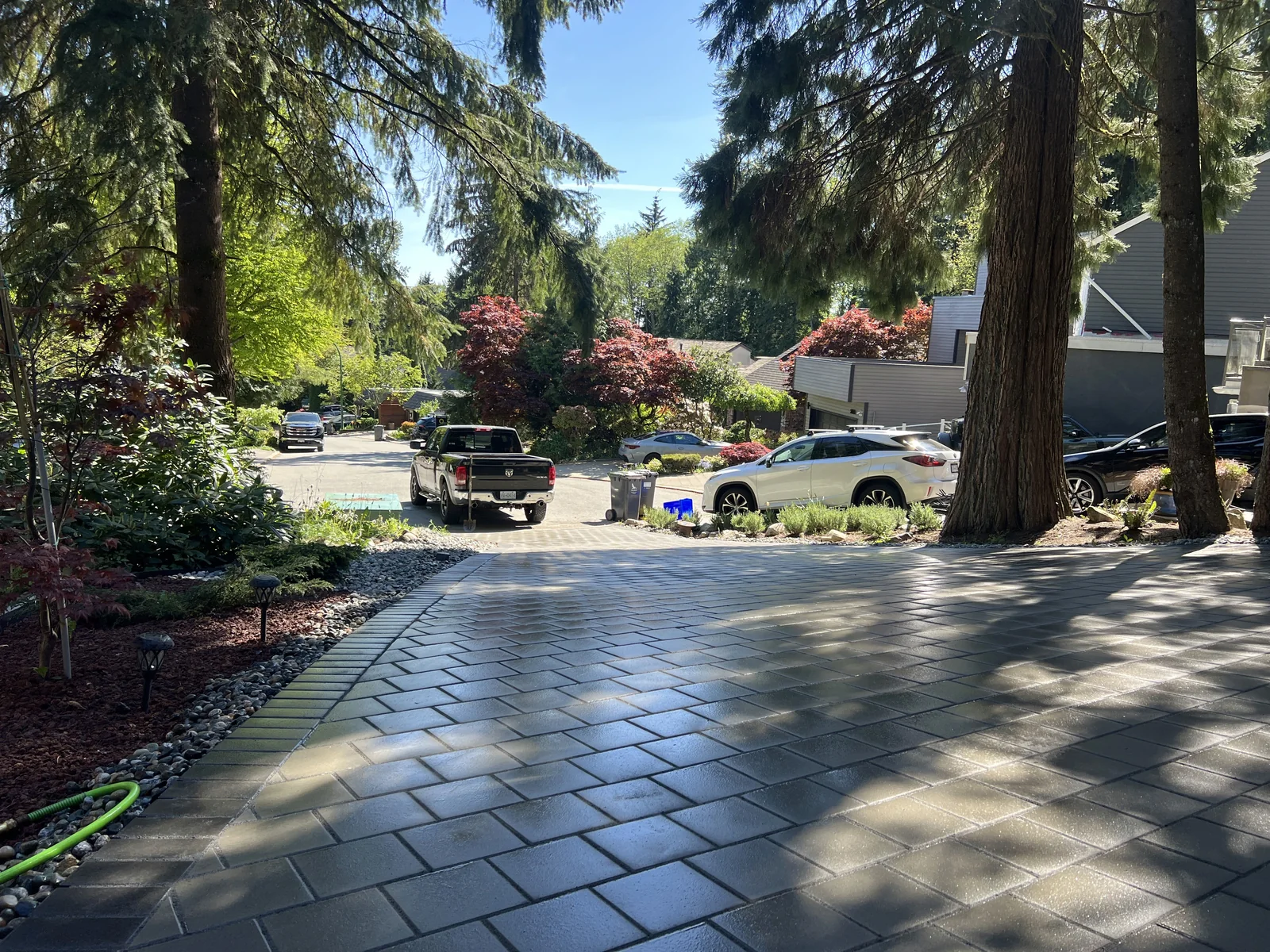 Sleek Outdoor Entrance — paver driveway and minimalist dry garden in North Vancouver, BC.